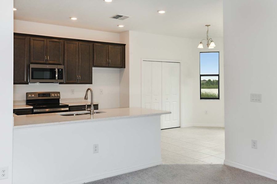 Juno home plan kitchen and dining room view from great room William Ryan Homes Tampa