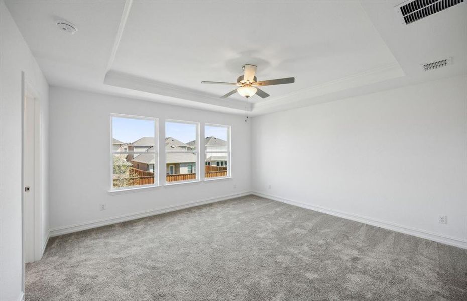 Elegant owner's suite with tray windows *real home pictured