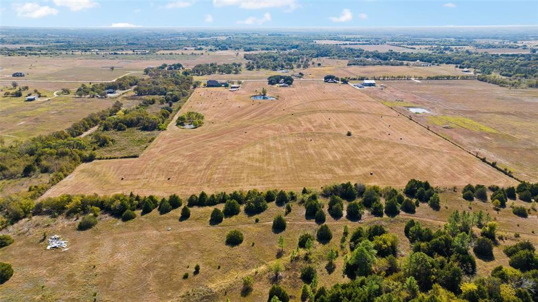 Birds eye view of property featuring a rural view