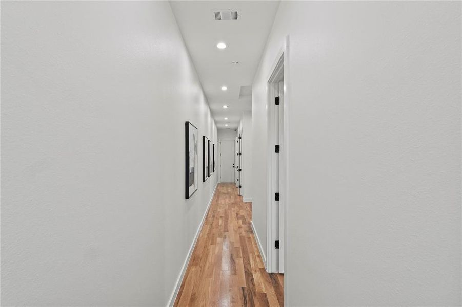 Hallway with light hardwood / wood-style floors