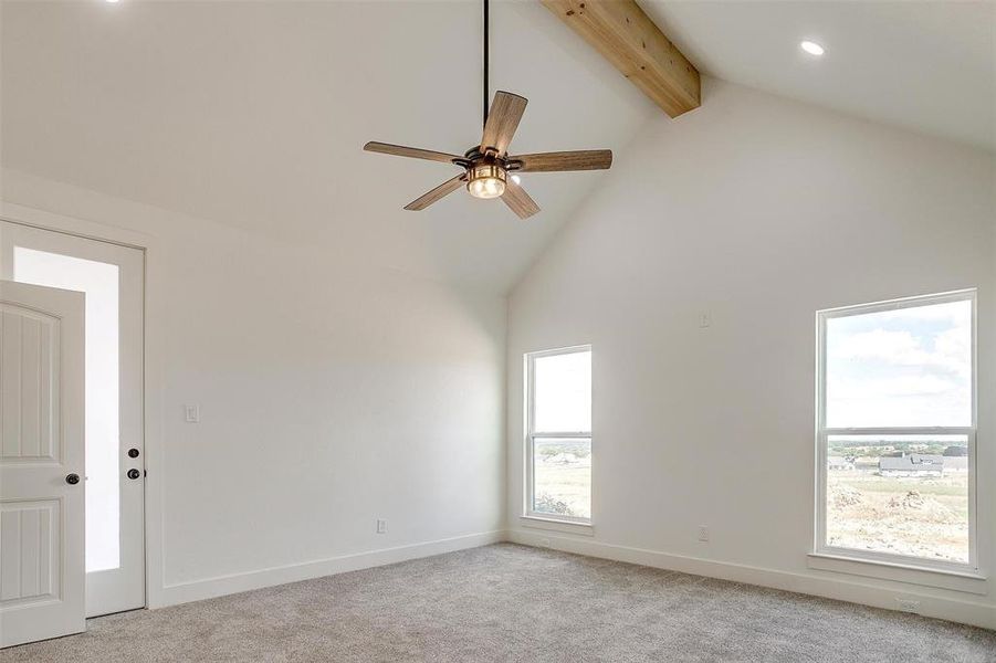 Spare room with high vaulted ceiling, ceiling fan, light colored carpet, and beamed ceiling