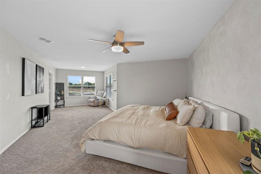 Bedroom with light carpet and ceiling fan