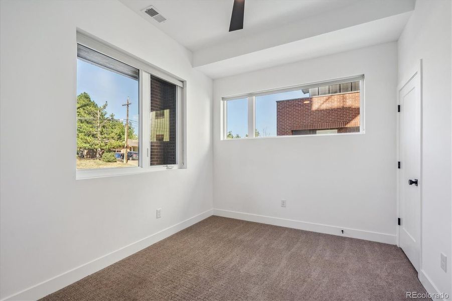 Spacious Secondary Lower-Level Bedroom with En-Suite Bathroom Provides the Flexibility for Private Guest Suite of Study/Home Office Workspaces.