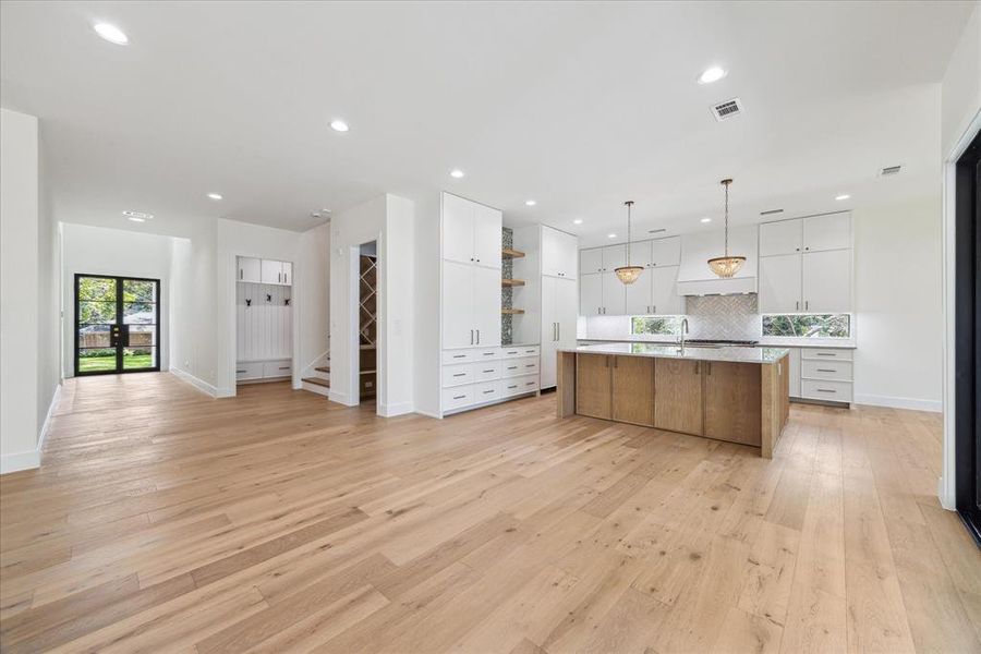 Close to the kitchen, the mudroom offers convenient access to the garage, making unloading groceries a breeze. Another fabulous amenity is the elegantly designed wine room, perfect for storing and showcasing your collection.