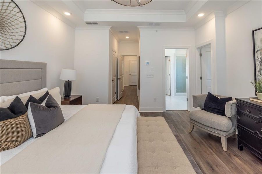 Master Bedroom with ensuite bath, hardwood / wood-style flooring, and a raised ceiling not the actual unit