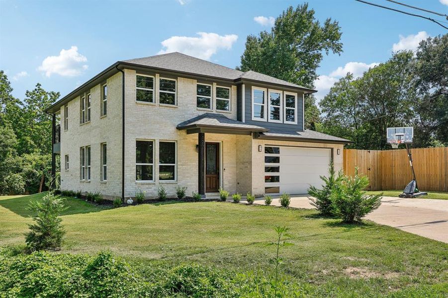 Prairie-style home featuring a garage and a front yard