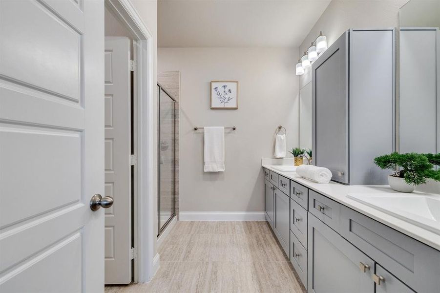 Bathroom featuring vanity and a shower with door