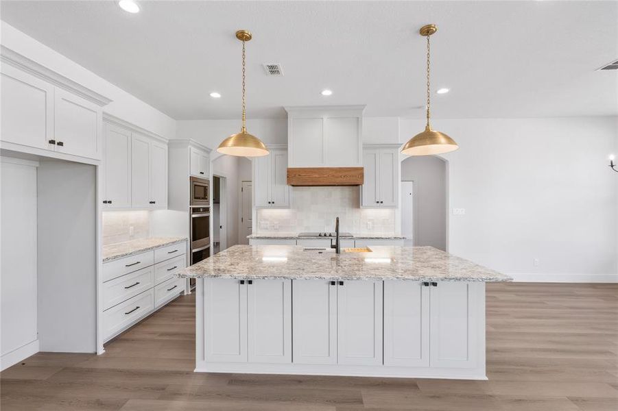 Anchored by the functional island this kitchen offers a cozy warm palette without compromising the natural light.