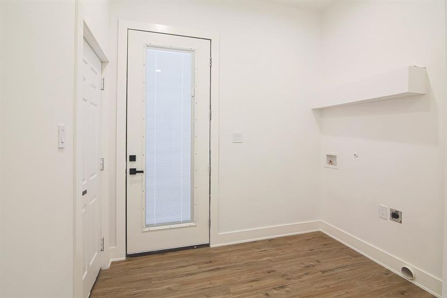 Laundry area with hookup for a washing machine, hardwood / wood-style flooring, and electric dryer hookup