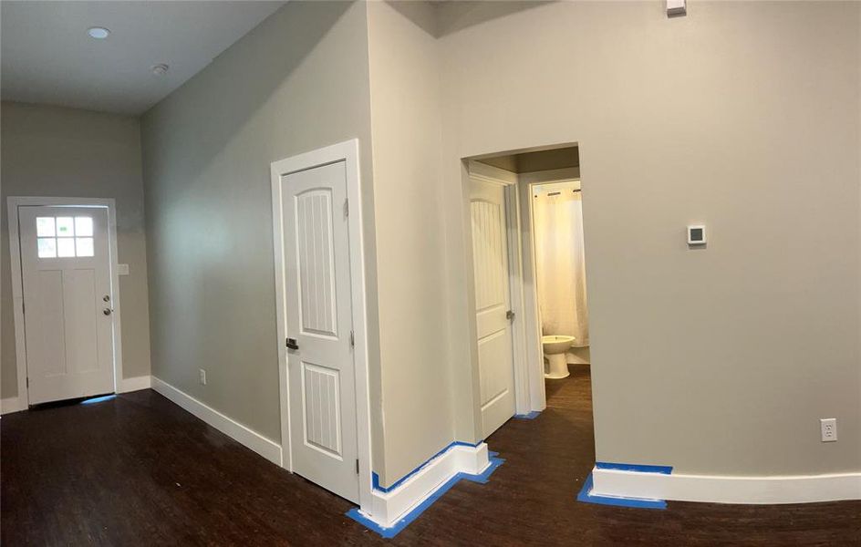 Foyer with a high ceiling and dark hardwood / wood-style flooring