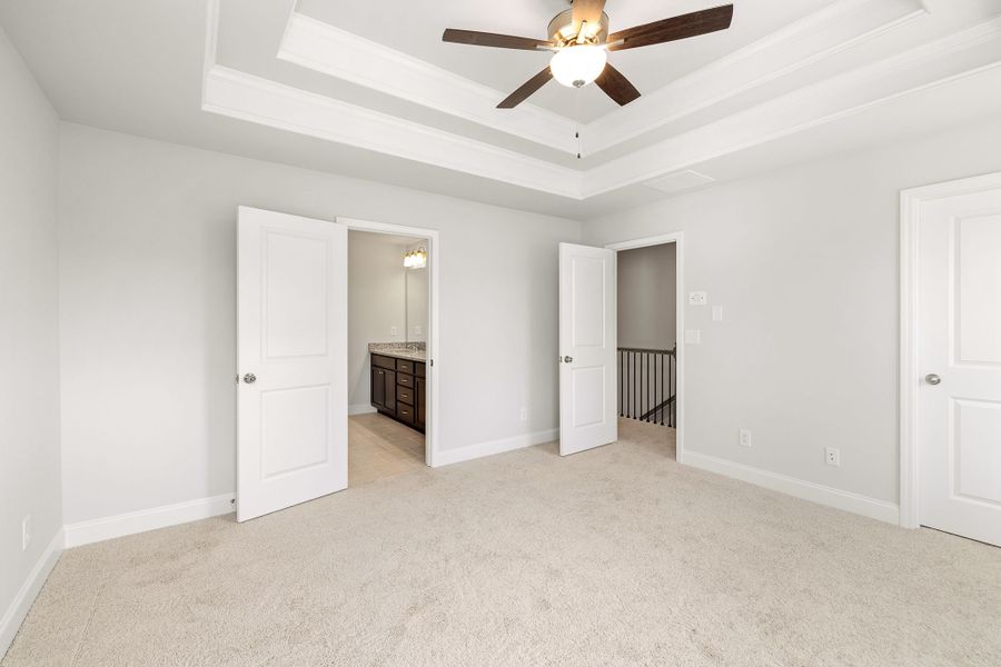 Master bedroom features a walk in bathroom and closet