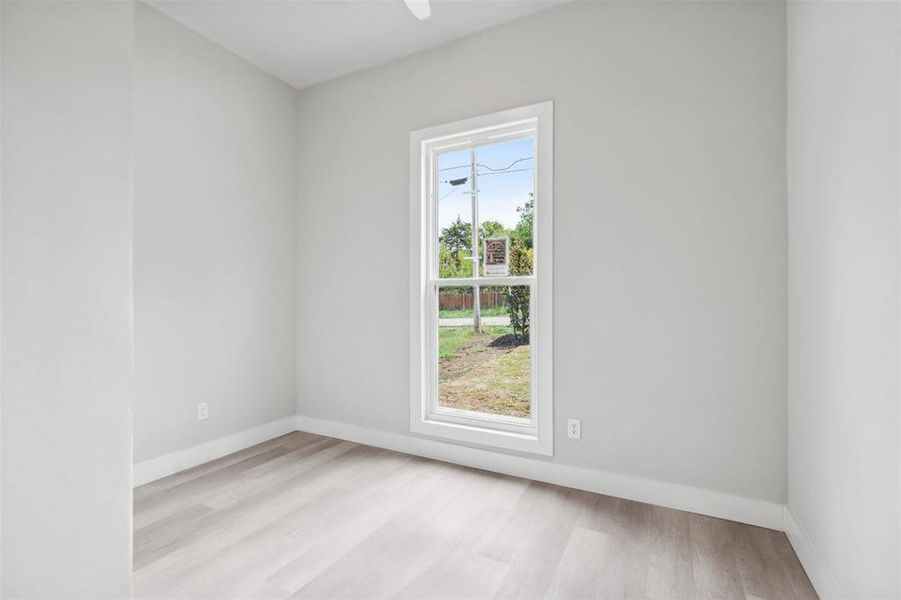 Spare room featuring light hardwood / wood-style flooring and a healthy amount of sunlight