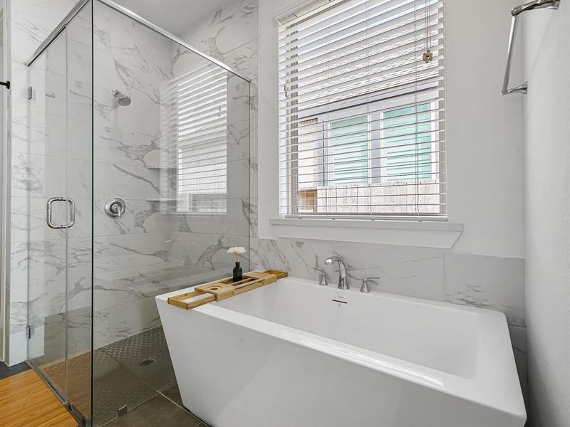 Imagine unwinding after a long day in your very own soaking tub, nestled in a serene bathroom that exudes tranquility. This exquisite space invites you to indulge in a calming retreat, complete with soft lighting and elegant fixtures that enhance the ambiance.