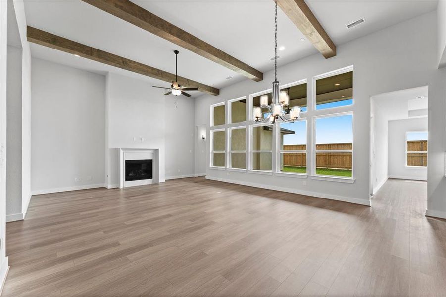 Family Room/Dining with Gas Log Fireplace, Ceiling Beams, and LVP Flooring