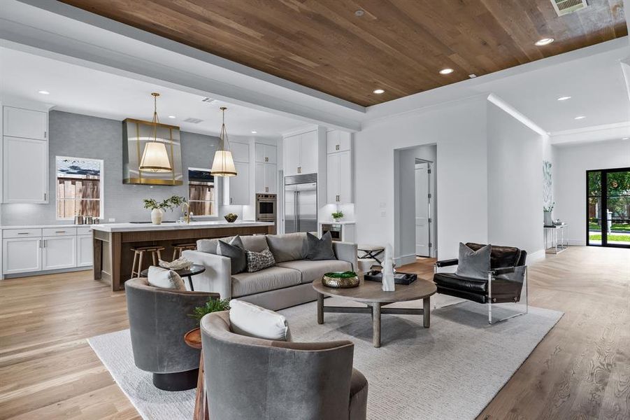 Living room featuring light hardwood / wood-style floors, sink, and wood ceiling