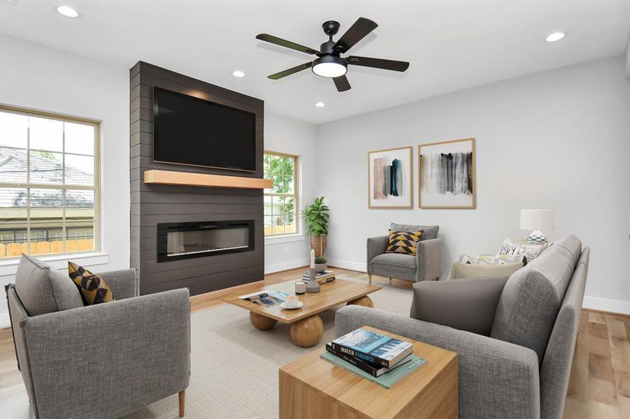 The living area is a spacious 16'9"x 14'4", and features large windows and a wonderful electric fireplace for cozy evenings at home! Photo virtually staged.