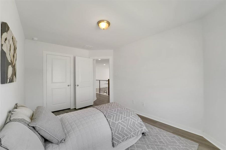 Bedroom with hardwood / wood-style floors