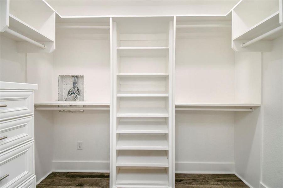 Main retreat walk-in closet with built-in shelving and cabinetry.