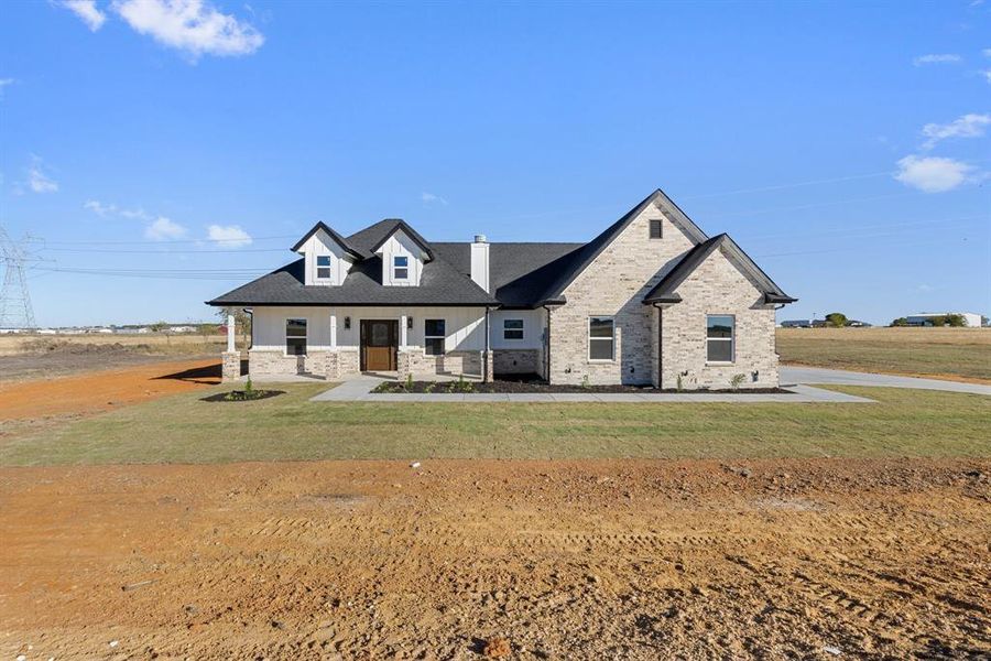 View of front of house featuring a front lawn and a porch