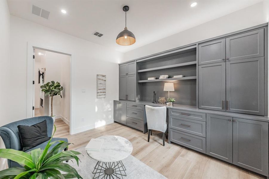 Home office with light blonde plank, wood-like luxury vinyl floors.