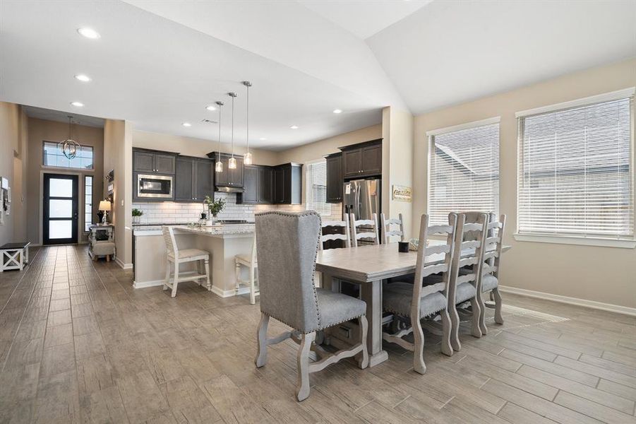 Make memories gathered around the table with your family and friends! This dining room features high ceilings, large windows and all open to the kitchen and family room, making entertaining a breeze!