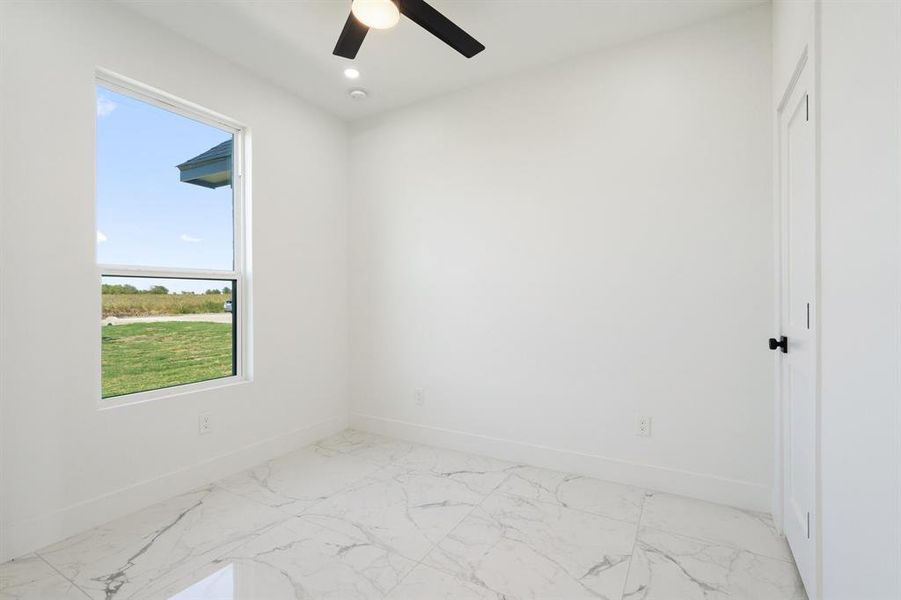 Empty room featuring ceiling fan