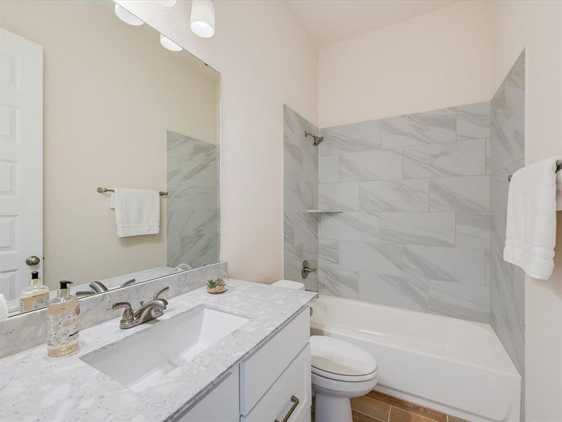 Beautiful secondary bath with upgraded counters and tile surround.