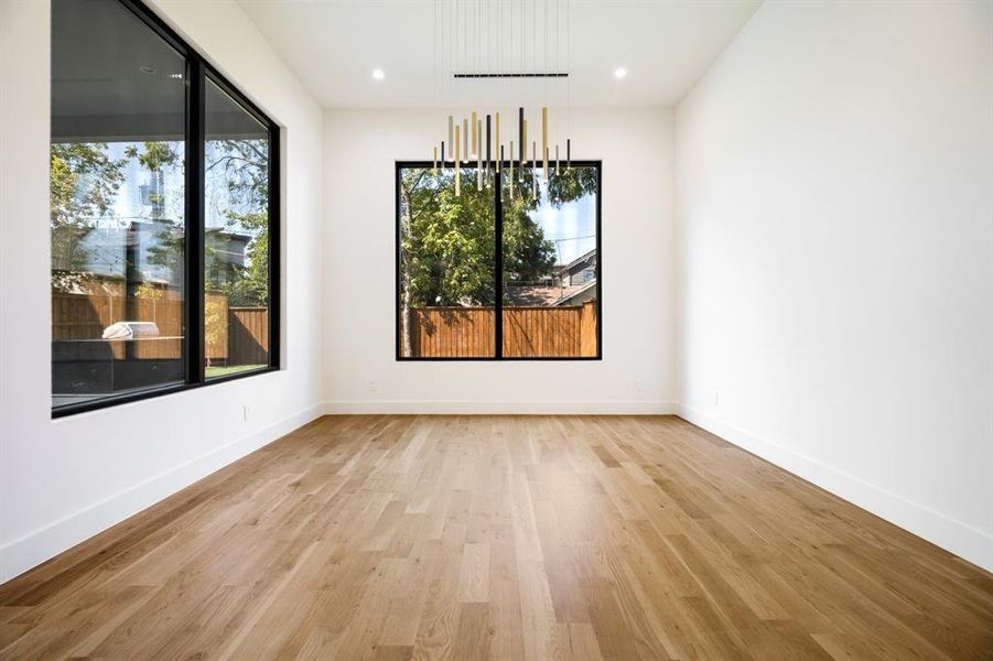 Unfurnished dining area featuring plenty of natural light and light hardwood / wood-style flooring