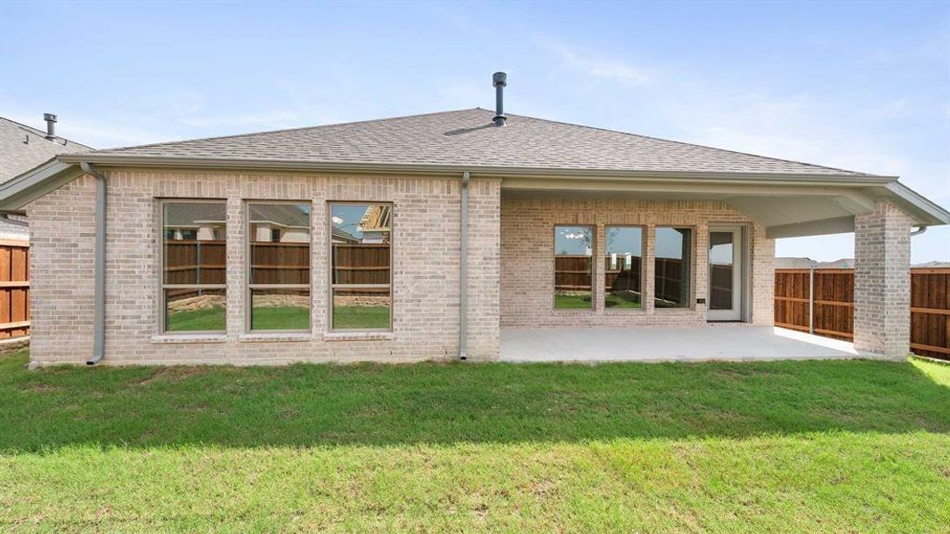 Back of house featuring a patio and a yard