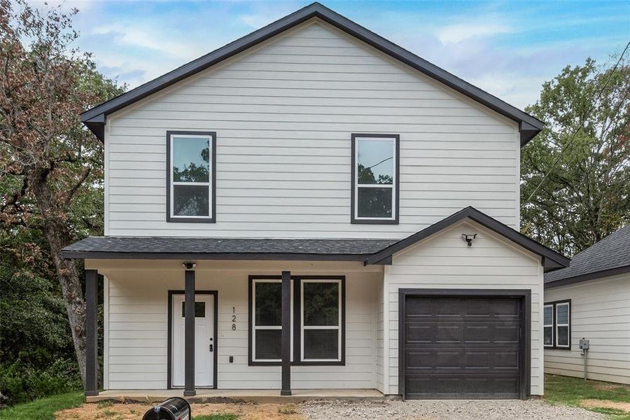 View of front of property featuring a garage