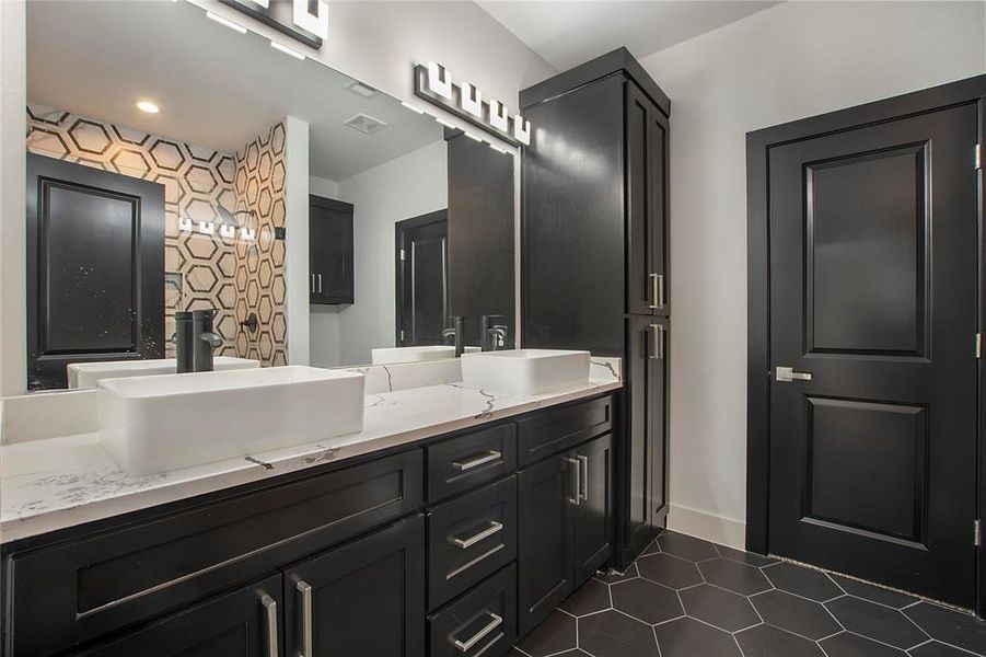 Bathroom featuring vanity and tile patterned floors