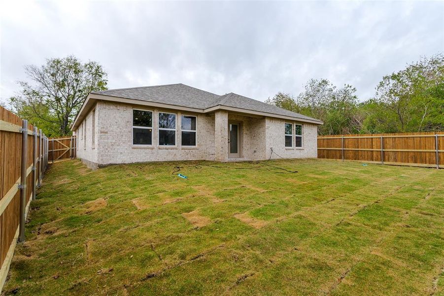 Rear view of house with a yard