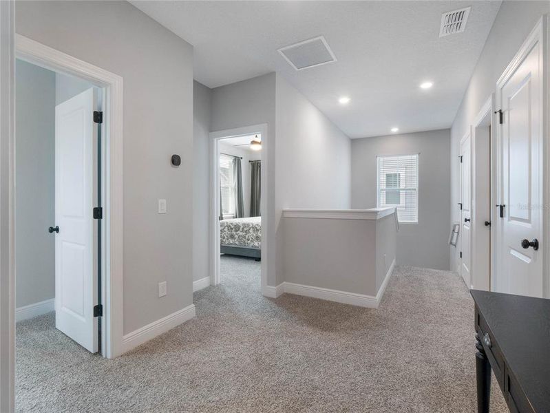 large hallway in between the secondary bedrooms