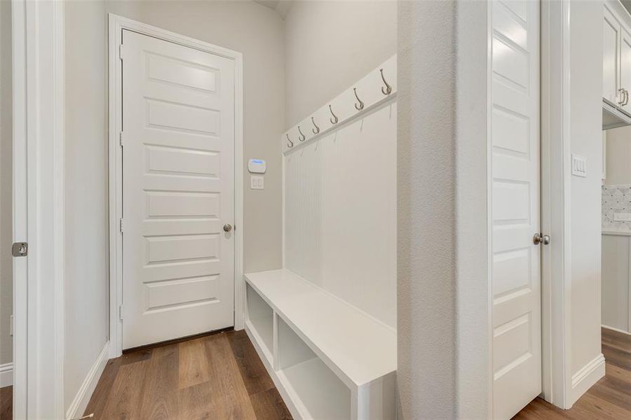 Mudroom with wood-type flooring