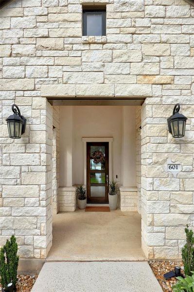 Beautiful glass front door welcomes you, offering a sneak peek of the lake views!