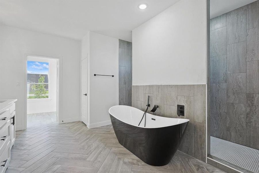 Bathroom featuring independent shower and bath, vanity, and parquet floors