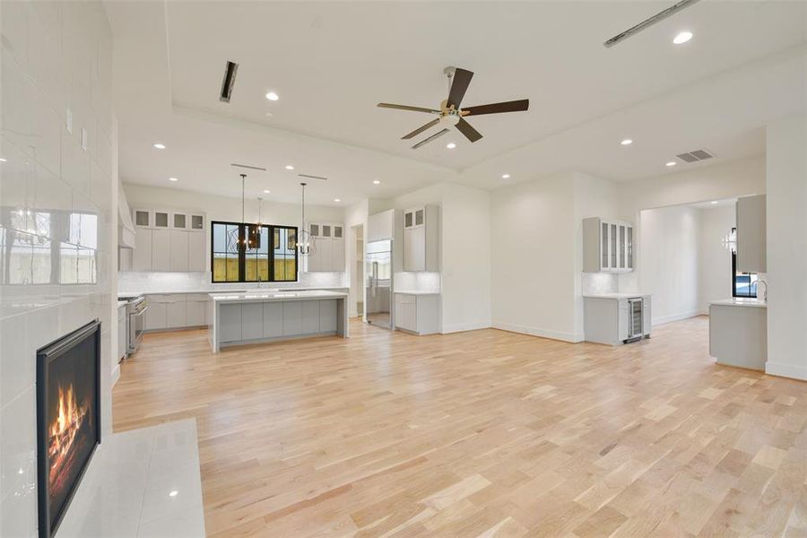 The main living area flows seamlessly between the kitchen, the butler's pantry to the dining room and back to the study. Access to the primary bedroom is offset by a vestibule entry behind the photographer.