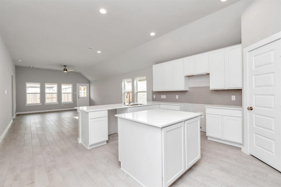 All of this overlooks your expansive family room, creating a perfect space for culinary delights and family gatherings. Sample photo of completed home with similar floor plan. As-built interior colors and selections may vary.