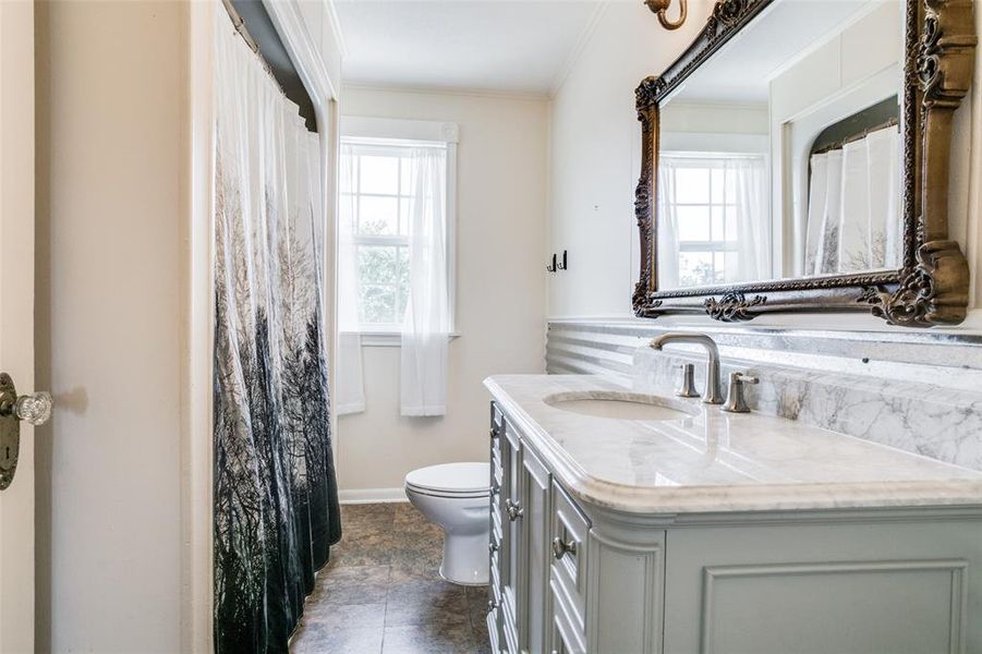 Bathroom with vanity, a wealth of natural light, tile patterned flooring, and toilet