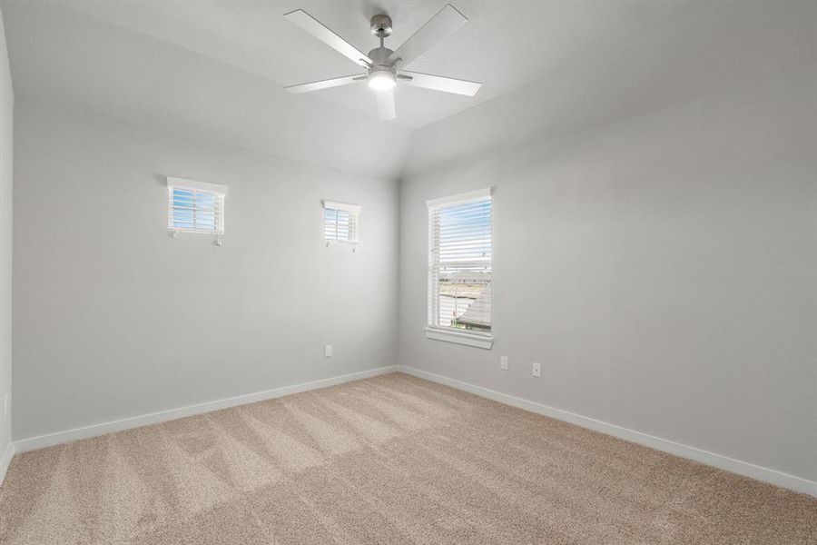 Elegance meets functionality in the secondary bedrooms, showcasing 5-panel doors with modern hardware, large windows adorned with privacy blinds, and walk-in closets boasting sleek and contemporary finishes. Sample photo of completed home with similar floor plan. Actual colors and selections may vary.