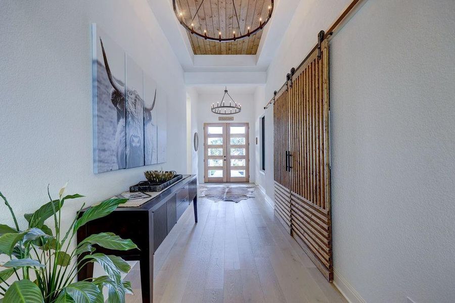 Grand Foyer with High Ceilings, Wood Accents, Double Doors & Custom Barn Doors to Office