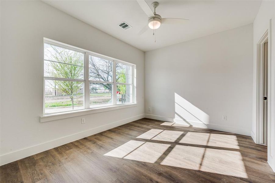 Empty room with ceiling fan and hardwood / wood-style floors