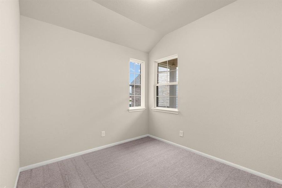 Your secondary bedroom features plush carpet, fresh paint, closet, and a large window that lets in plenty of natural lighting.