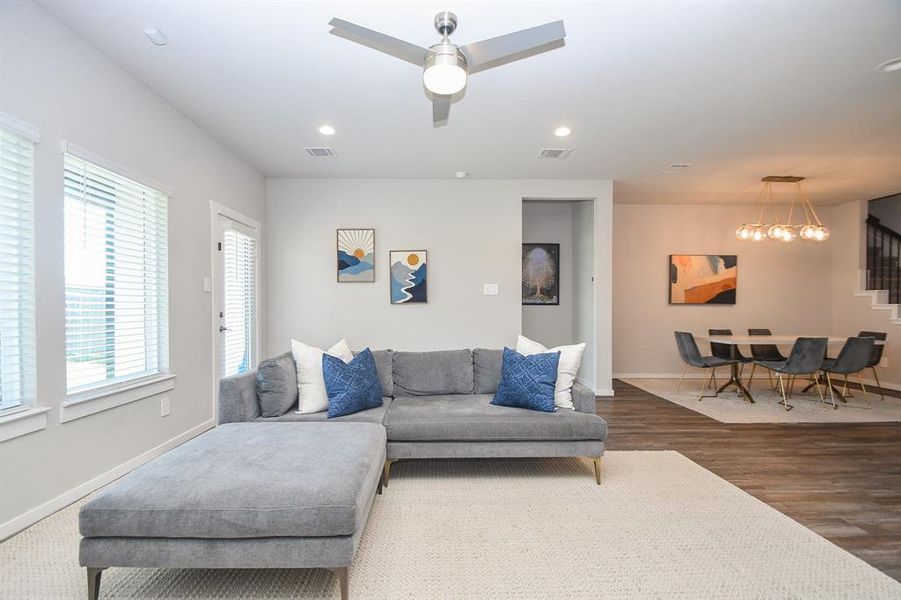 Dining and living room with ample seating and an open floor plan.