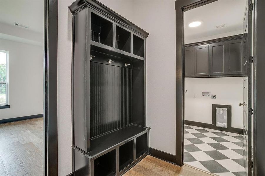 Mudroom featuring light tile floors