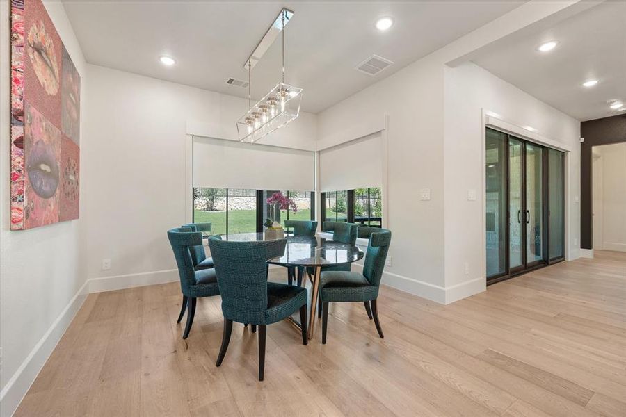 Dining room with light hardwood / wood-style flooring