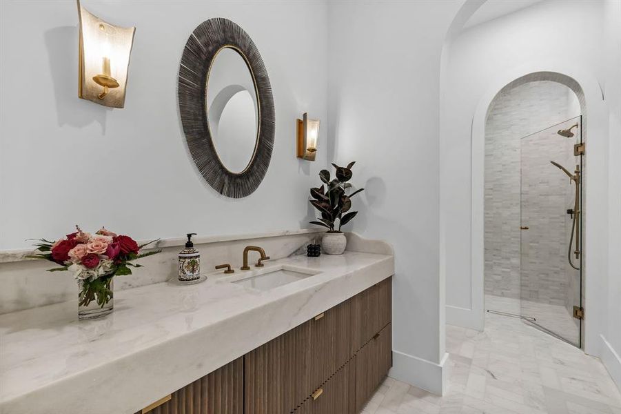 Bathroom with vanity and a shower with shower door