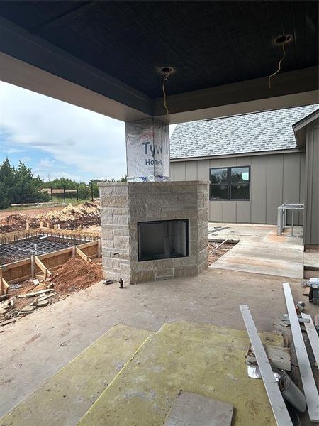 Outdoor living, complete with FP looks out to the pool and huge backyard.