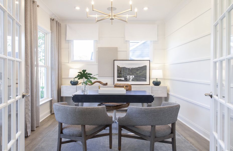 Flexible living space with classic French doors off of foyer