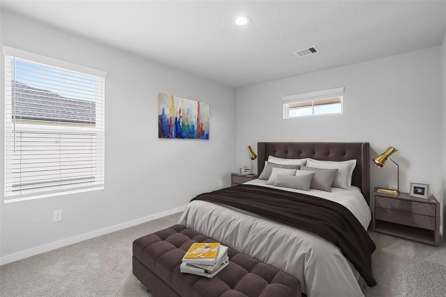 Secondary bedroom features plush carpet, custom paint, lighting, and large window with privacy blinds.